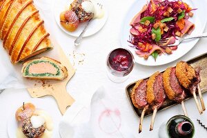 A Christmas meal with salmon en croûte, loin of venison, red cabbage and baked apple