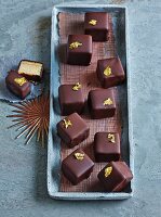 Cubes of Baumkuchen (or 'tree cake' because of its many layers that resemble the rings on a tree trunk) with gold leaf for Christmas