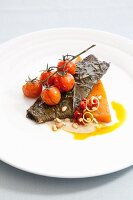 Fillet of Red Drum fish with fried cherry tomatoes and pine nuts