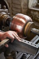 Copper sheet being sanded down at the Kupfermanufaktur Weyersberg copper factory in Baden-Württemberg, Germany