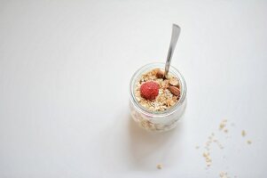 Honey and almond muesli with raspberries in a glass
