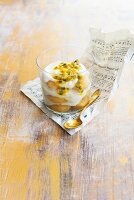 Coconut tiramisu with passion fruit sauce in a glass