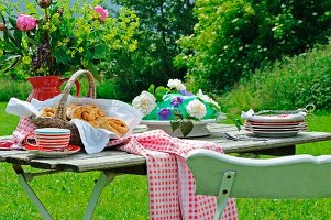 Cinnamon rolls and a marzipan cake on a garden table