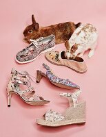 Various summer shoes with floral print and two bunnies next to them