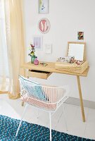 A metal chair in front of an elegant-looking desk used as a make-up table in a bedroom