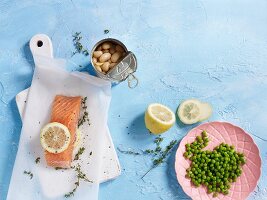 Ingredients for salmon in parchment paper with peas