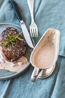 A fried beef filet steak with creamy red wine sauce