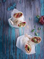 Sweet breakfast wraps with peanut butter, raspberries, avocado and popped amaranth seeds