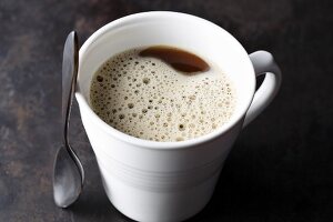 Bulletproof coffee with ground coffee, butter and coconut oil
