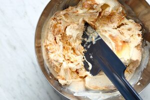 Vanilla ice cream being mixed with peanut butter