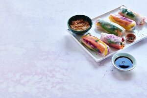 'Rainbow' raw vegetable summer rolls with peanut and orange dip