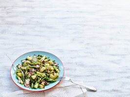 Potato salad with green asparagus, radishes and beluga lentils