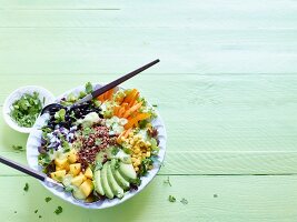 Brightly coloured quinoa and veggie bowl with avocado, mango and black beans