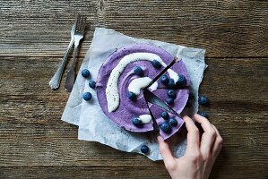 A sliced blueberry and cashew cake