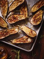 Baked aubergines on baking tray