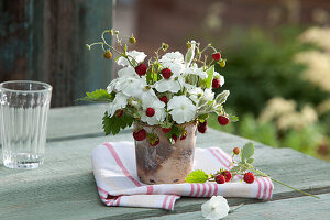 Small bouquet made from Lychnis coronaria 'Alba' (carnation) and Fragaria vesca (strawberries)