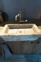 Rustic stone sink in dark kitchen