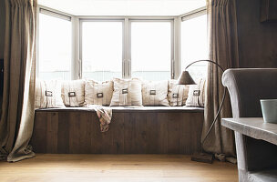 Cushions with buckles on window bench in window bay