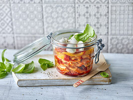 Spicy pasta salad with mozzarella to take away in a flip-top jar
