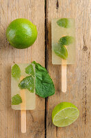 Mojito ice lollies on a wooden surface