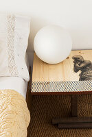 Spherical lamp on bedside table decorated with decoupage motif