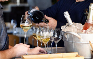 Server pouring wine in a restaurant