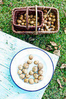Walnuts on a plate and in a basket in an Autumnal garden