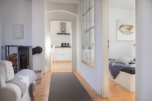 Converted dairy: Corridor between living room with log burner and bedroom with restored stable window in partition wall