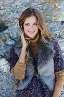 A long-haired woman wearing a fur gillet