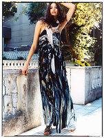 A young, long-haired woman wearing a printed summer dress