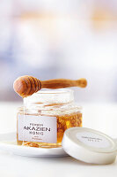 Acacia honey with walnuts and a honey dipper