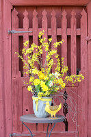 Spring bouquet of forsythia, ranunculus, cream narcissus, tulips, birch twigs and narcissus