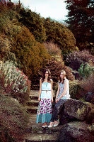 Two young women in a park wearing floral patterned outfits