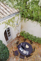 View down onto round garden table in Mediterranean courtyard