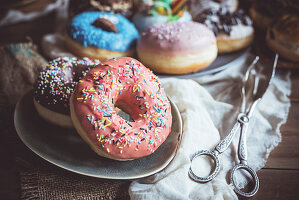 Sweet glazed donuts served in the plate, selective focus