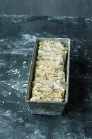 Unbaked pull-apart bread with herb butter and alpine cheese