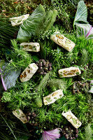 An arrangement of green shades made from vegetables, leaves and white nougat (full frame)