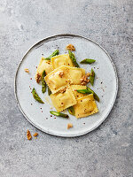 Goat's cheese ravioli with green asparagus, walnuts, chilli flakes and olive oil