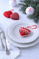Heart-shaped fabric Christmas tree decoration on plate
