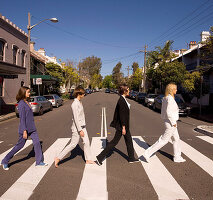Four women walking across a zebra crossing (The Beatles – remake)