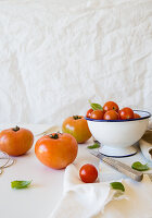Various tomatoes in and beside a bowl