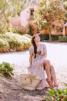 A young woman wearing a delicate pink summer dress