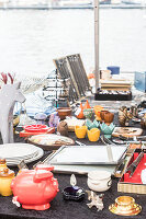 A mishmash of objects on a table at a flea market