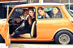 Young people with musical instruments in a Mini