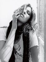 A young woman at a fence (black-and-white shot)