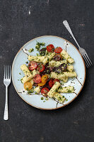 Rigatoni with wild garlic pesto, cherry tomatoes and black olives