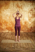 Mountain pose with hands on heart (yoga)