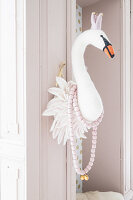 Faux swan head on door frame