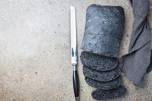 Sliced black bread colored with squid ink