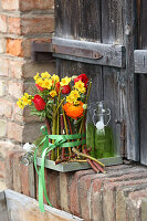 Red and yellow spring bouquet with tulips and narcissus